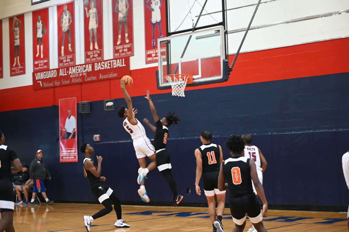 North Marion junior guard Brenden Barber goes in for the slam dunk in a Challenge Round game against Hawthorne on Saturday at the Kingdom in the Sun Tournament at Vanguard High School in Ocala. 